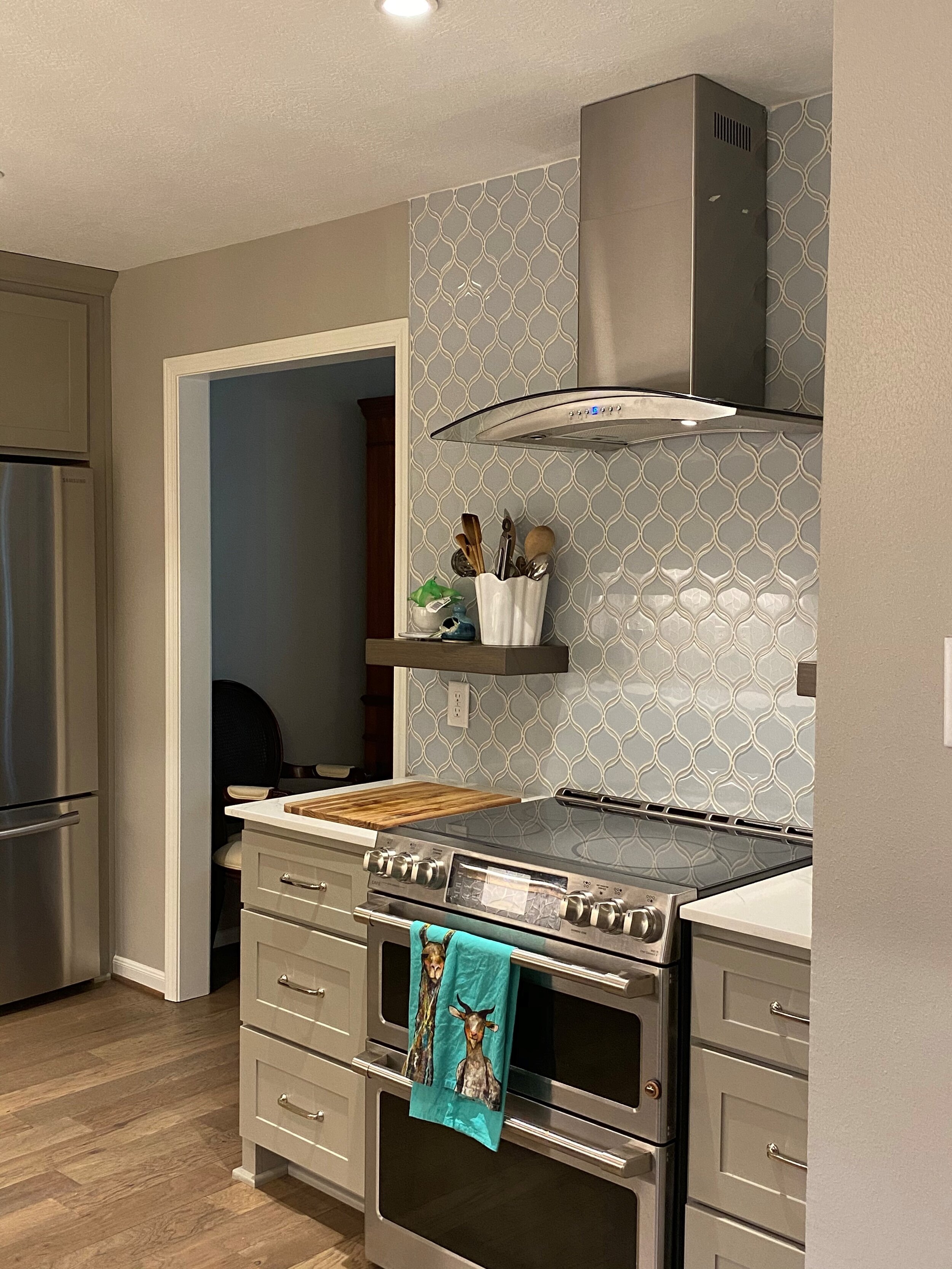 Interior Renovation - Woodlands, TX - Kitchen redesign with quartz counter top, glass tile back splash, floating shelves, appliances, and paint.