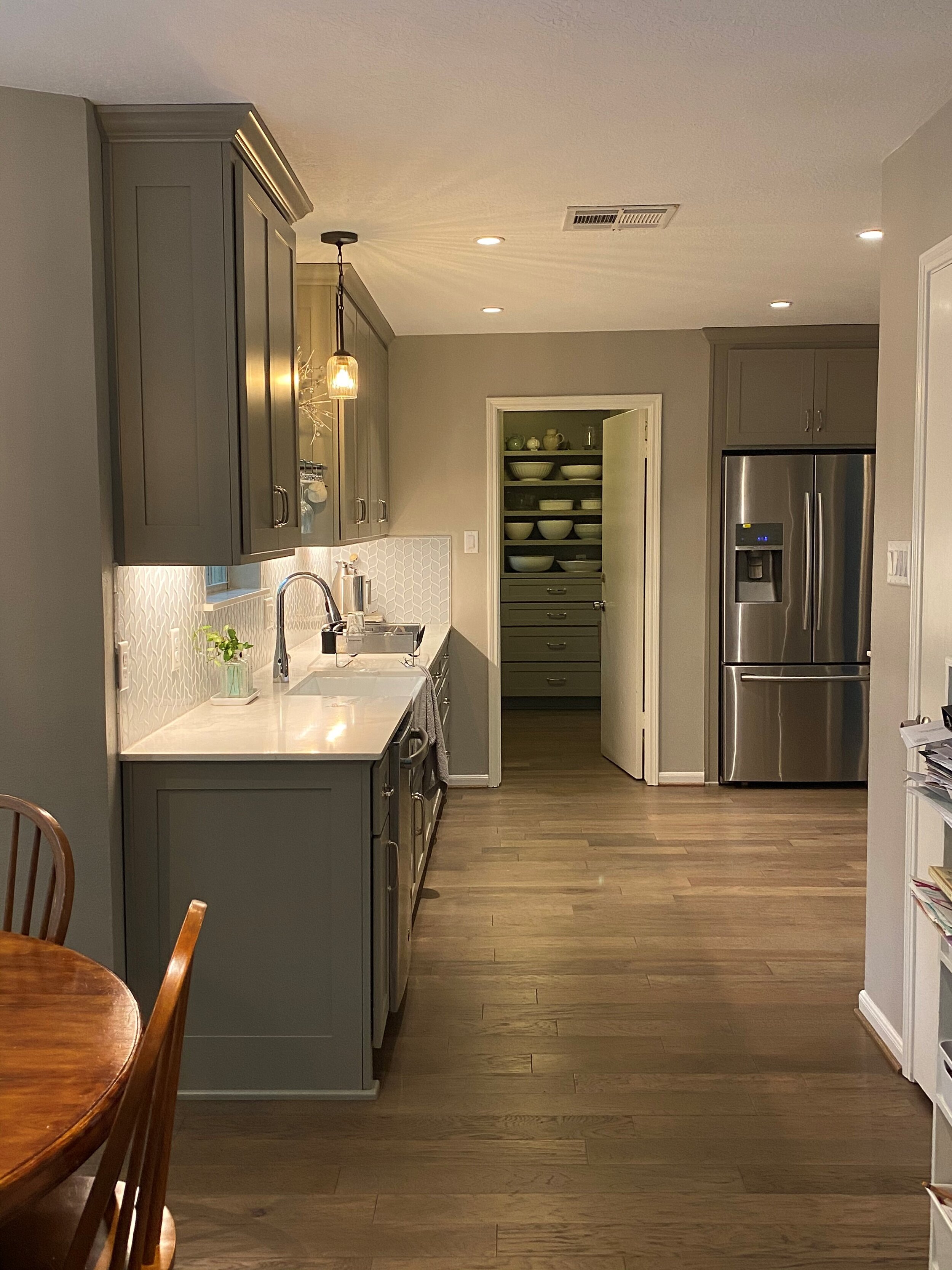 The Woodlands, TX - Full Renovation - Full kitchen remodel with quartz counter top, glass tile back splash, new lighting, full height storage in utility, flooring, cabinetry, and paint.