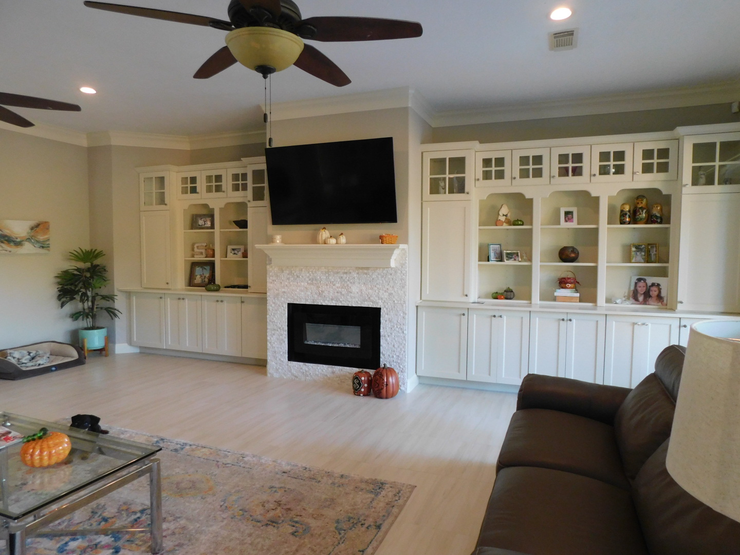 House Remodel in Wimbledon Estates - Living Room with new floor, cabinetry, windows, and paint