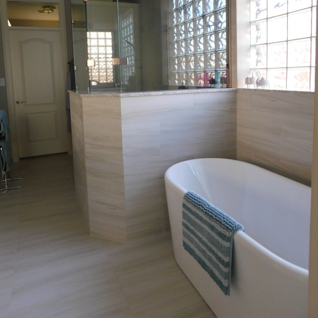 Master Bathroom in Spring, TX - Master bath redesign with freestanding tub, shower re-configuration, frame-less glass, plumbing fixtures, and flooring.
