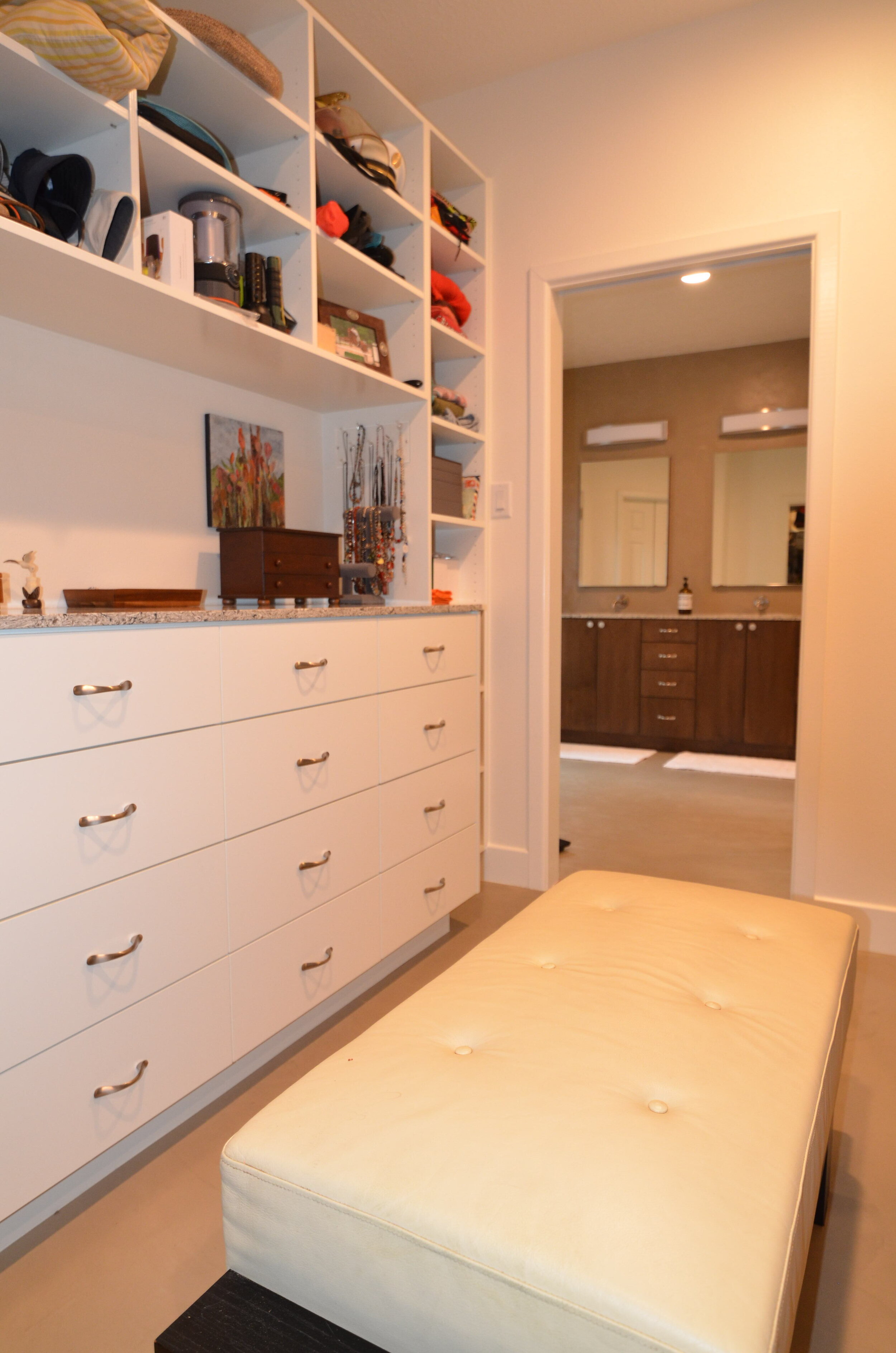 Remodeled Master Bath &amp; Closet in Conroe - New custom built closet with open shelving, lowers, full height cabinets, hanging rods, and pull down hangers 