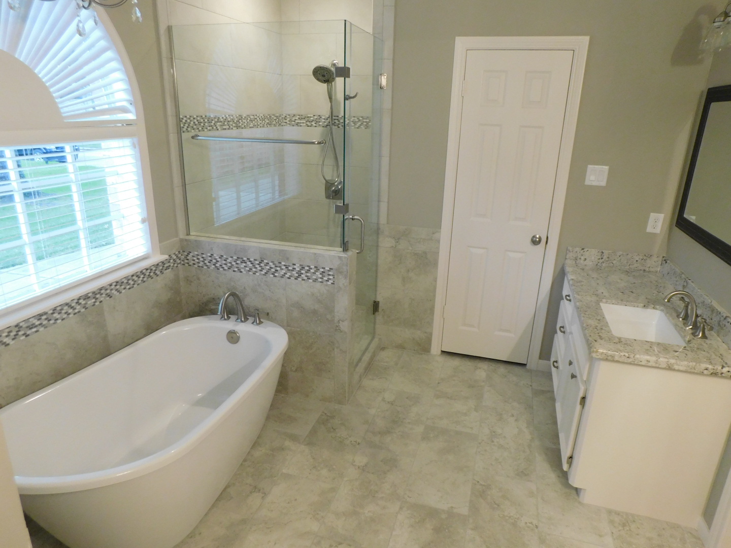 Master Bath Renovation in Spring - Freestanding tub, deck-mounted tub faucet, walk-in shower with frame-less glass, flooring, countertops, and paint