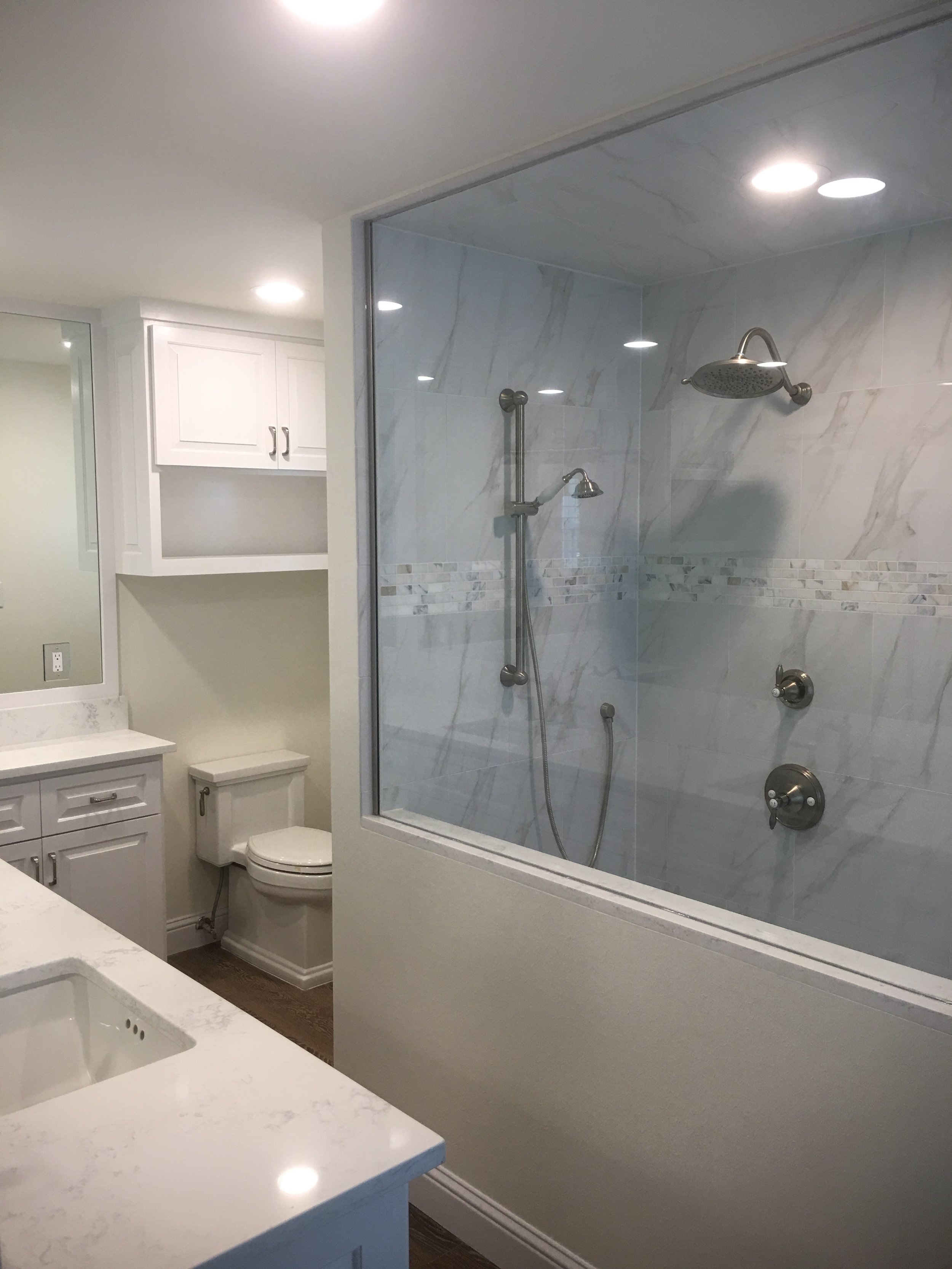 Master Bathroom Renovation Houston - Removed two walls to open up bathroom and toilet area, custom cabinet, frame less glass, walk-in shower. Bathroom redesign