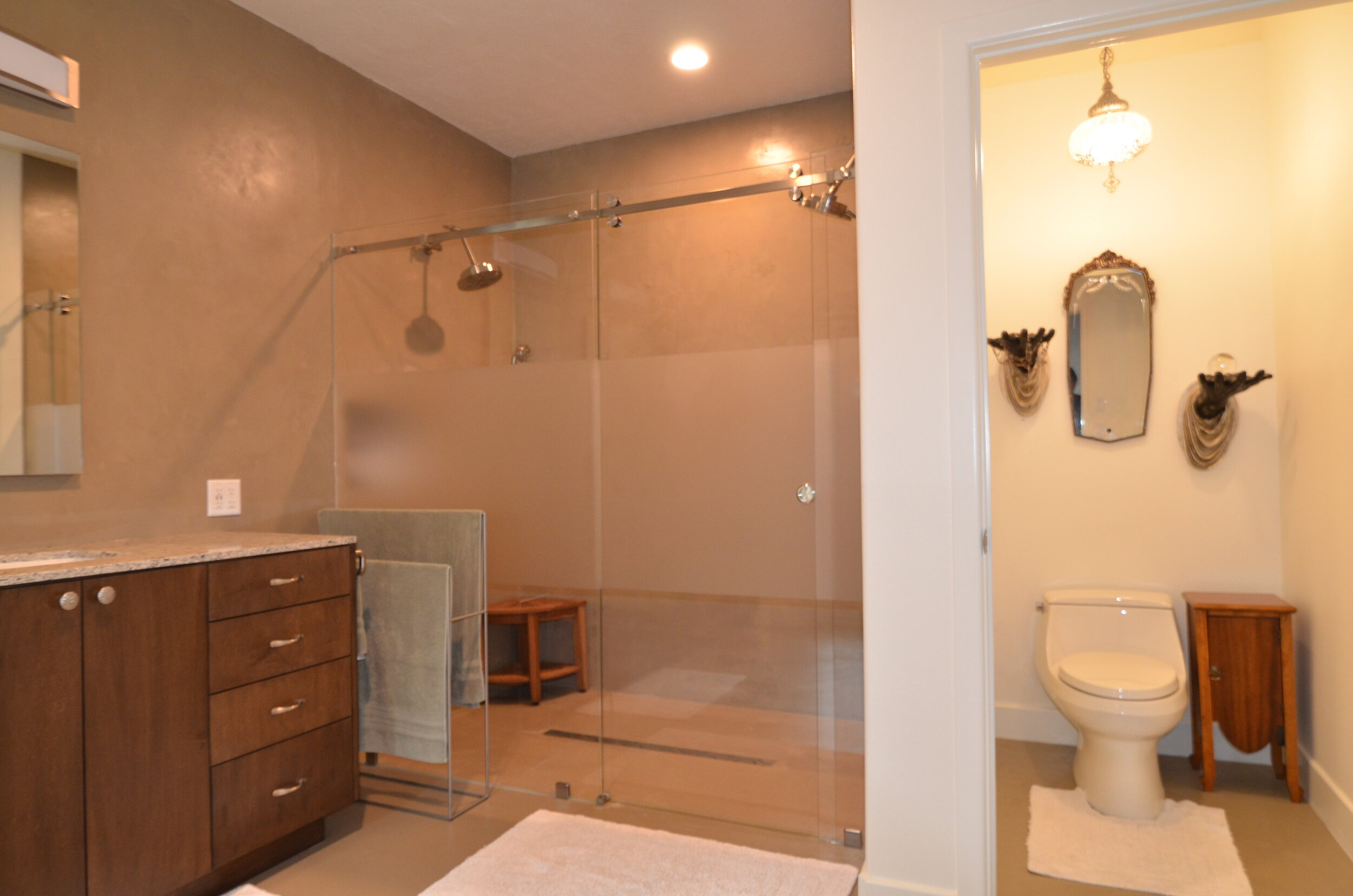Master Bath in Conroe - Seamless walk-in shower, sliding shower door with frosted glass band, maple stained cabinetry