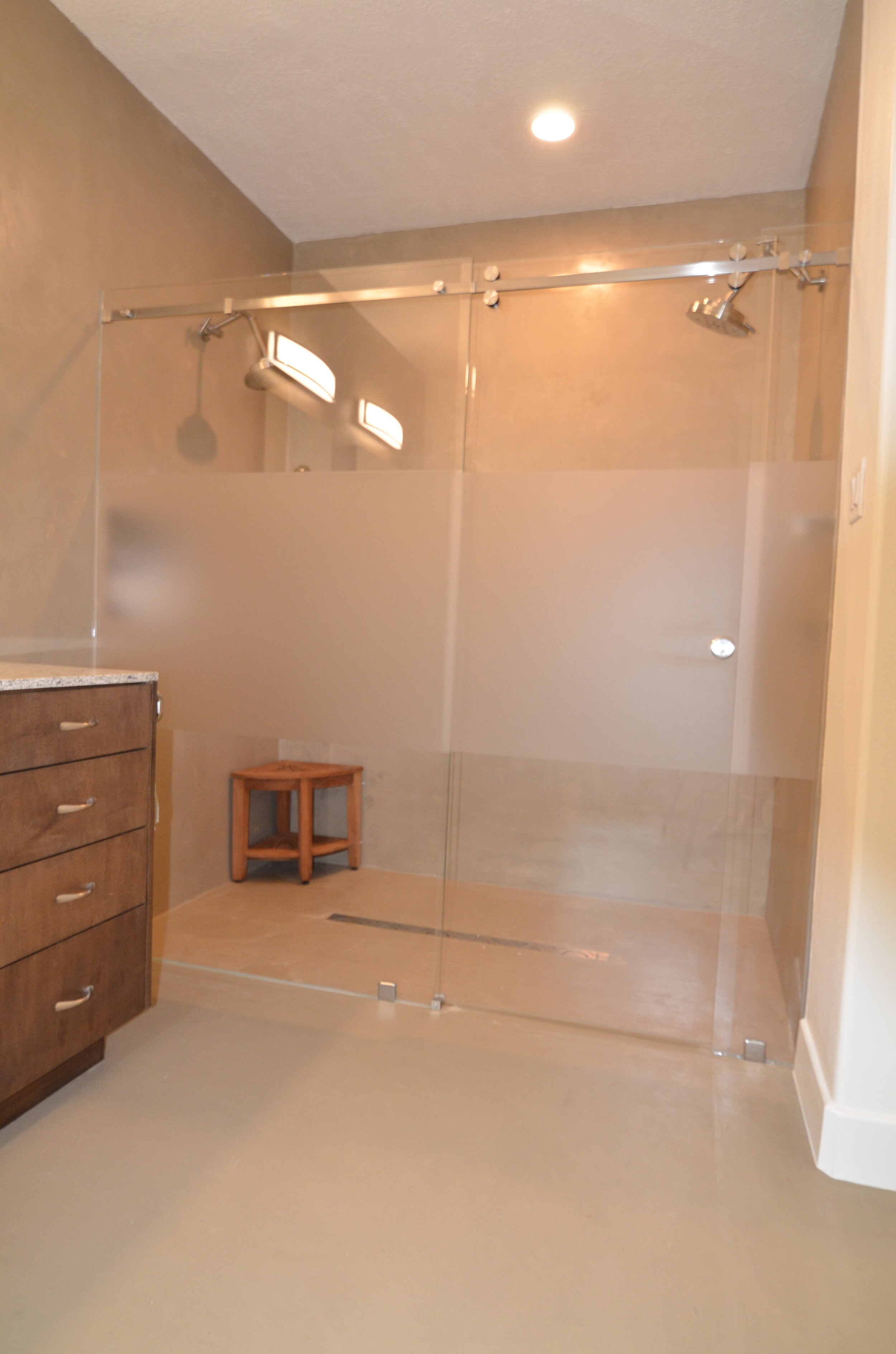 Master Bathroom &amp; Closet in Oak Ridge - Re-designed layout of bathroom for shower, closet, and water closet.  New vanity cabinet, build out for medicine cabinets, seamless shower entry with sliding door and privacy band.