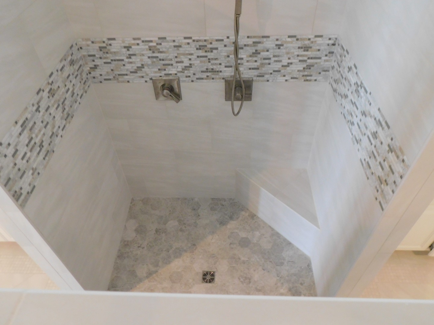 Master Shower Remodel Conroe - Re-designed open shower concept with corner bench and freestanding wall