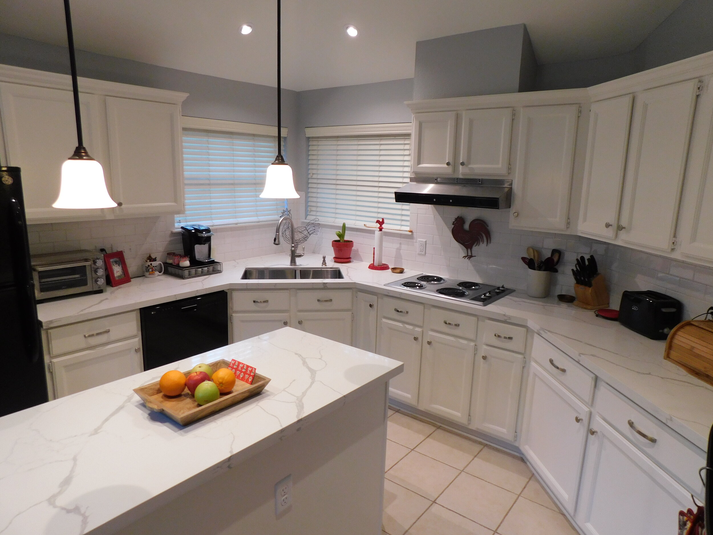 Kitchen remodel in The Woodlands - New countertops, backsplash, plumbing, hardware, and paint.