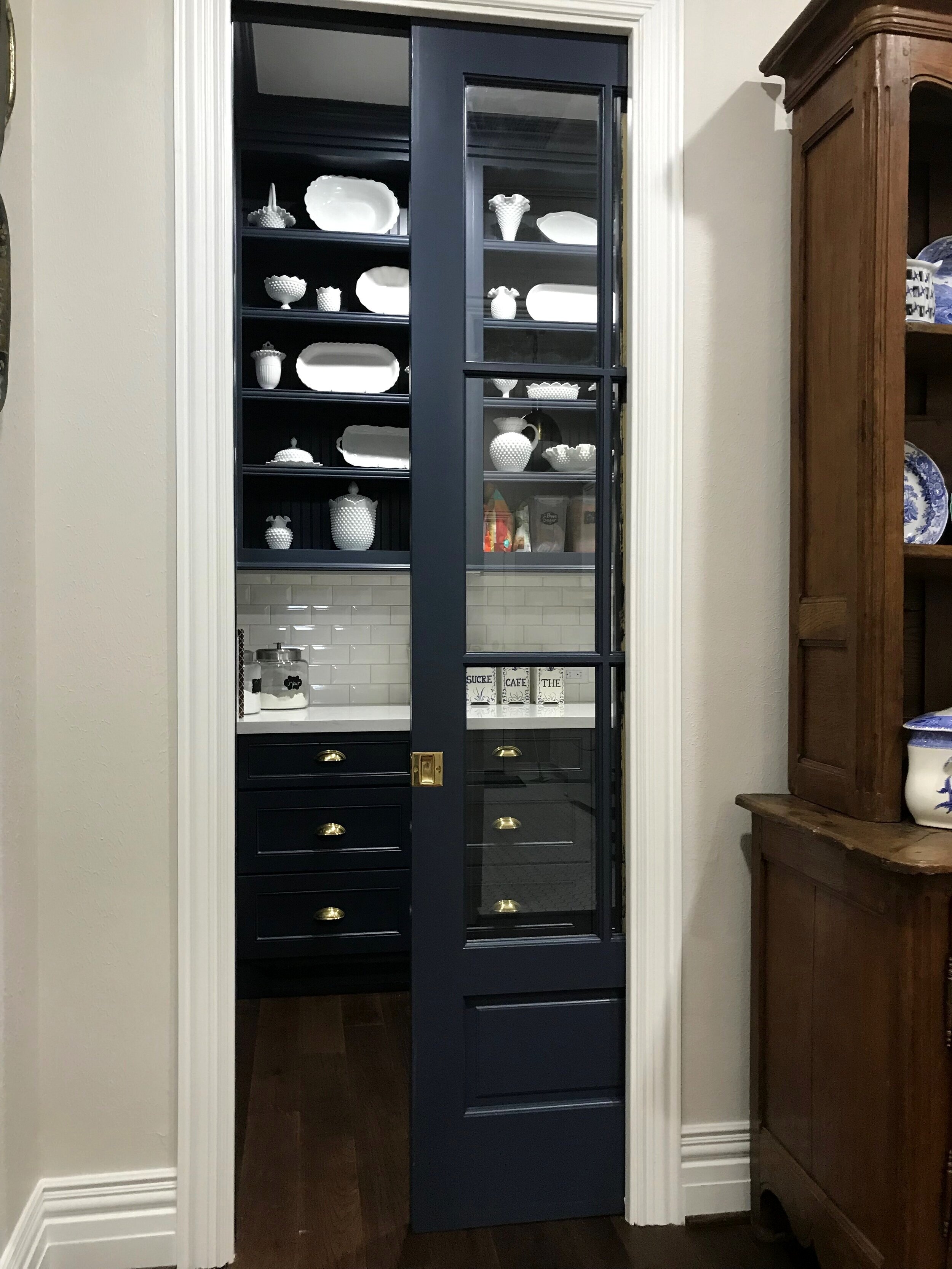 Interior Remodel in Rock Creek - Butler’s pantry with pocket door, quartz counter top, handmade tile back splash, and custom cabinetry