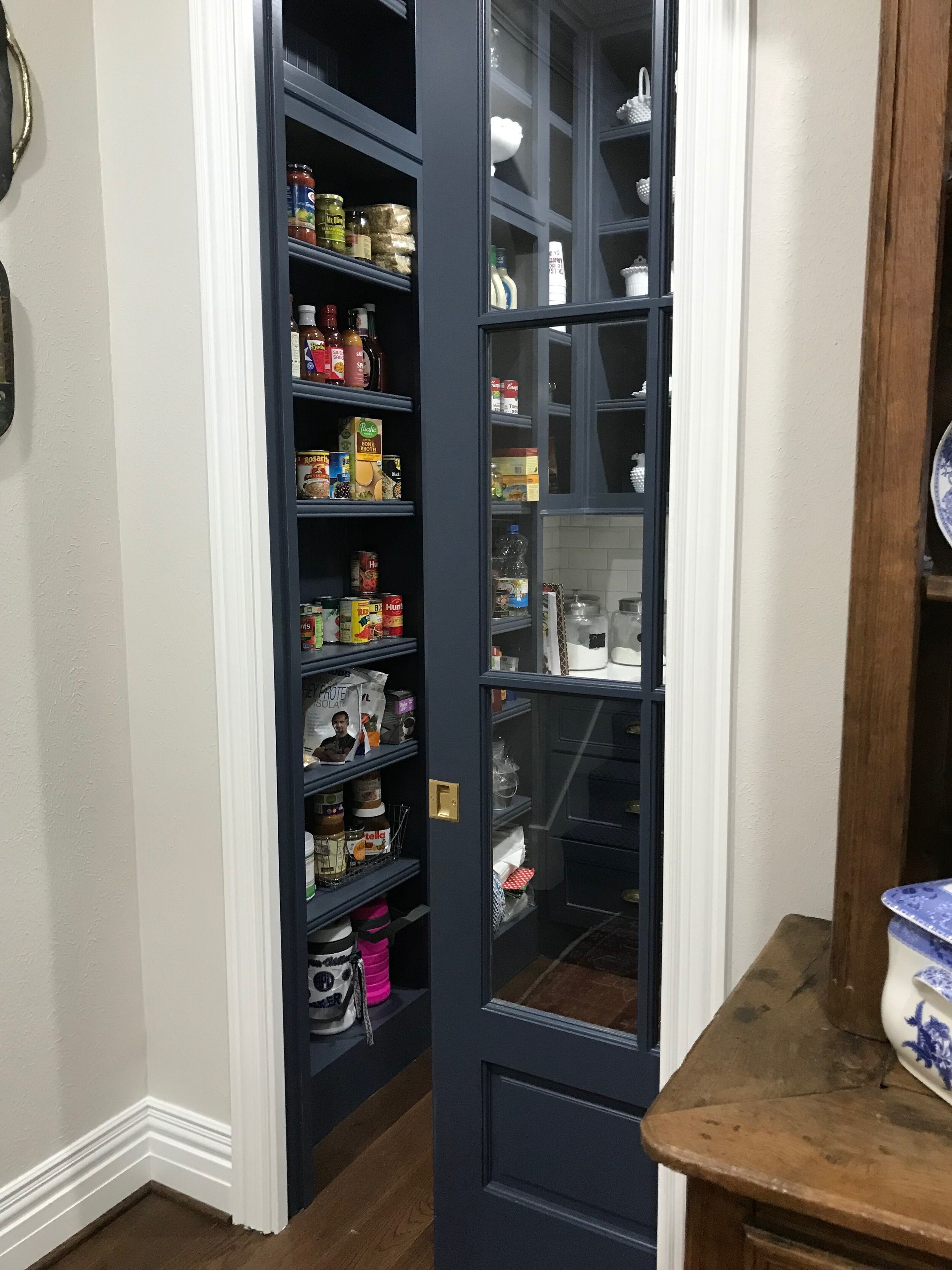 Rock Creek interior remodel - New enlarged pantry with pocket door, custom cabinetry, quartz counter top, and handmade tile back splash.
