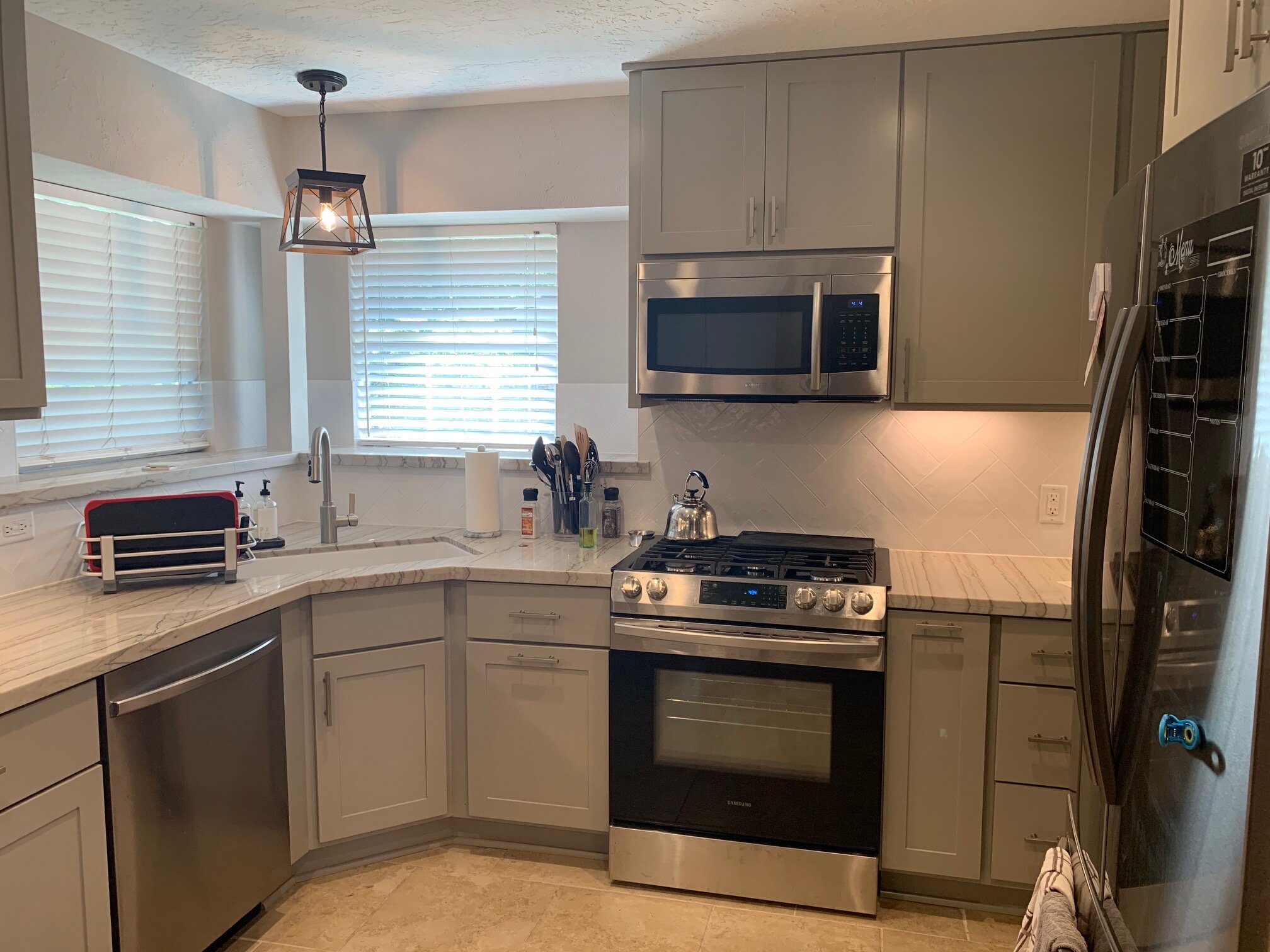 Interior Kitchen Remodel in Champions - New cabinetry, countertops, paint, electrical, plumbing, and back splash.